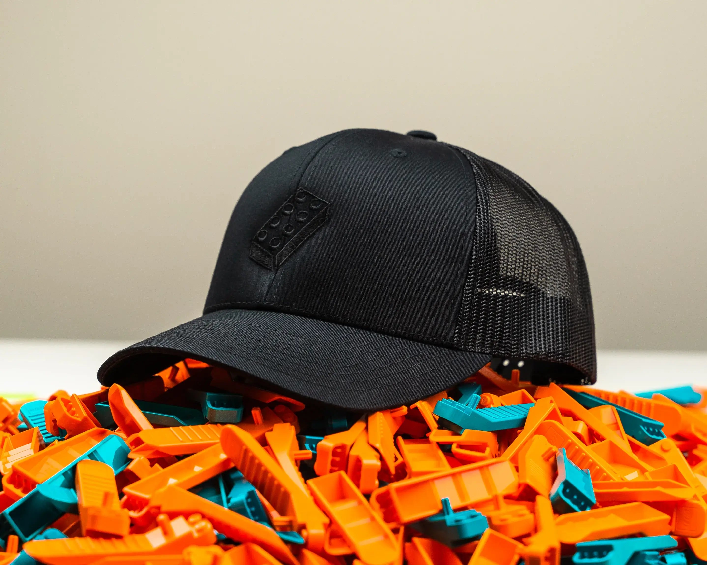 black hat with a brick seperator on it sitting on a pile of brick sperators