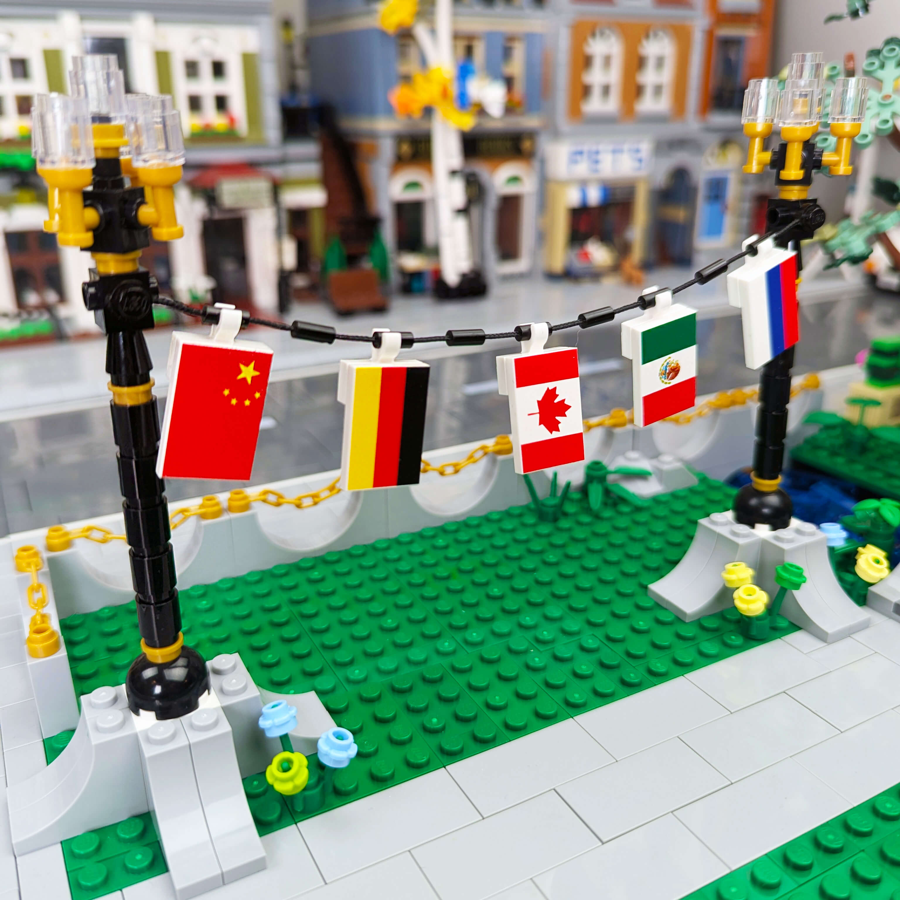 China, Germany, Canada, Mexico, & Russia country flags hanging in a Lego city scene.