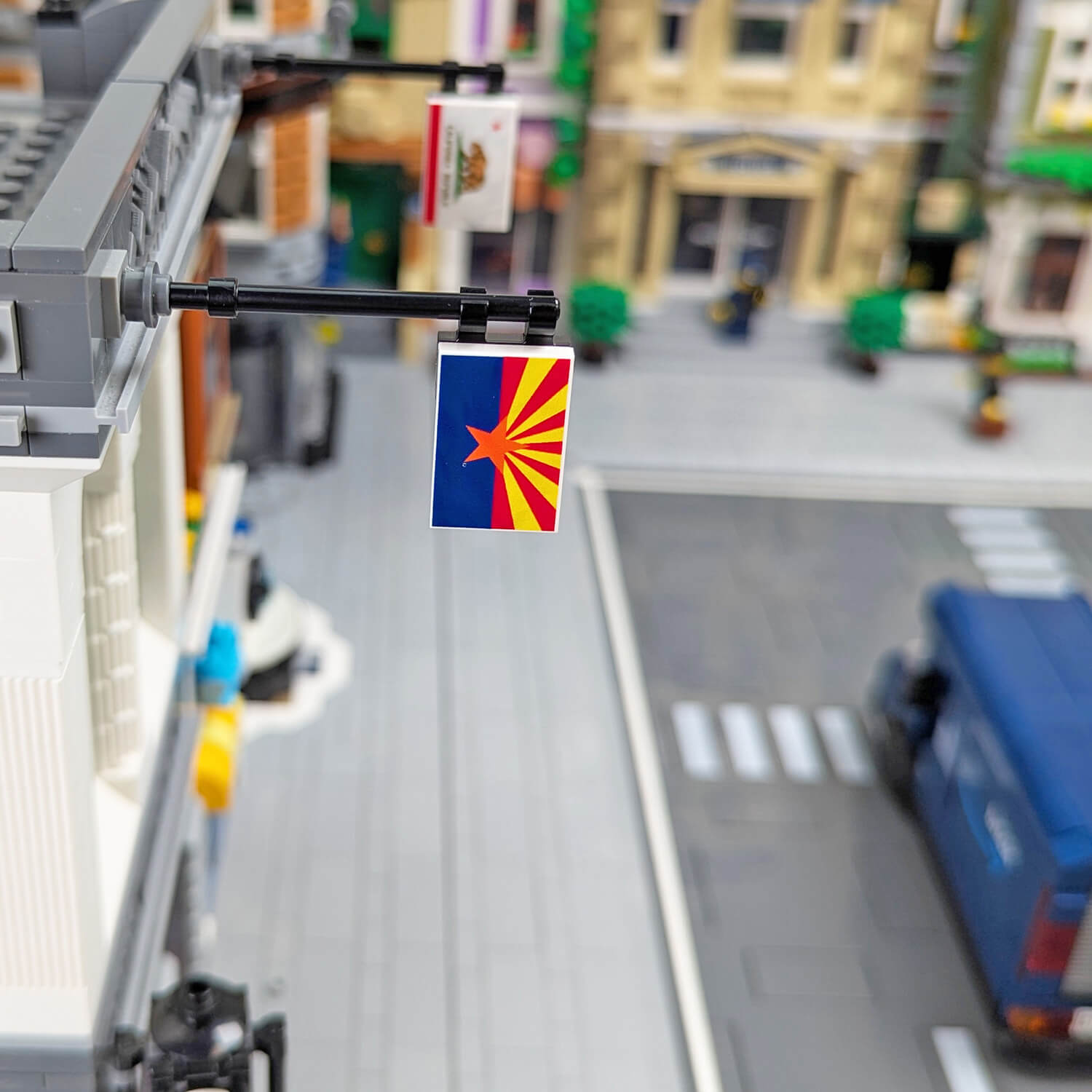 Close-up of a LEGO street with a Arizona state flag hanging from a building.