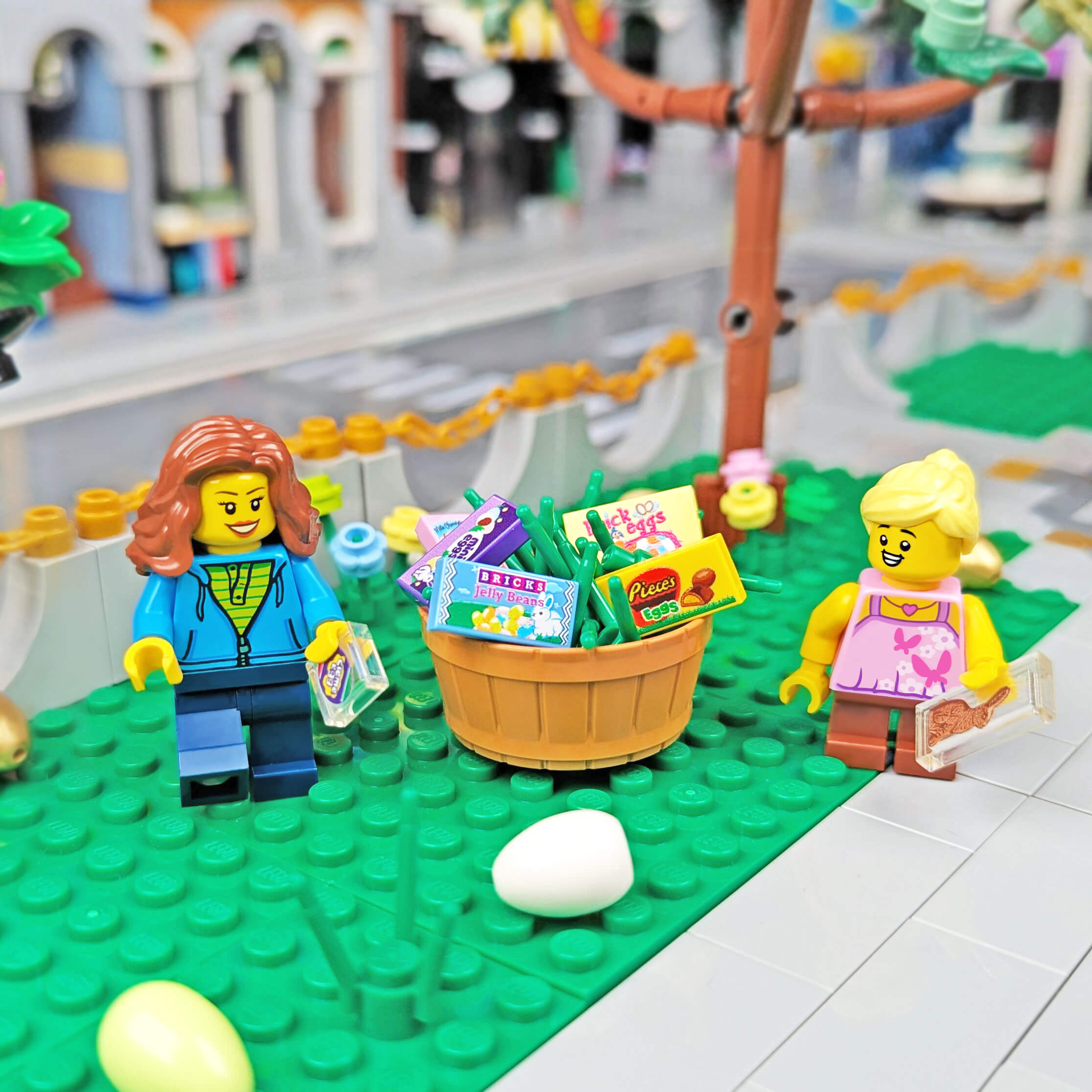 A scene with two lego minifigures standing next to a basket full of Easter candy printed on 1x2 LEGO tiles