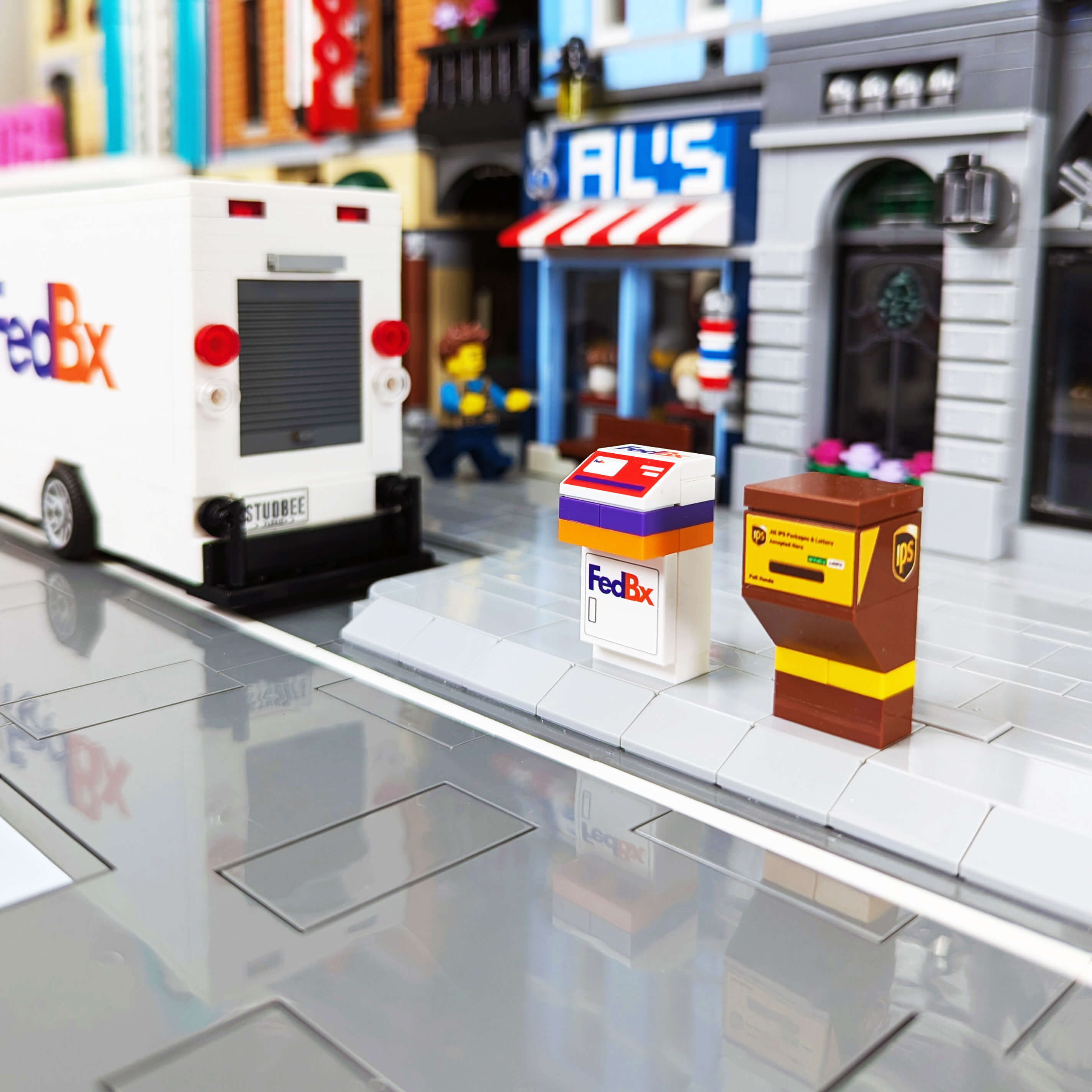 fedbx and ips shipping box in a lego city with a fedex truck in the background