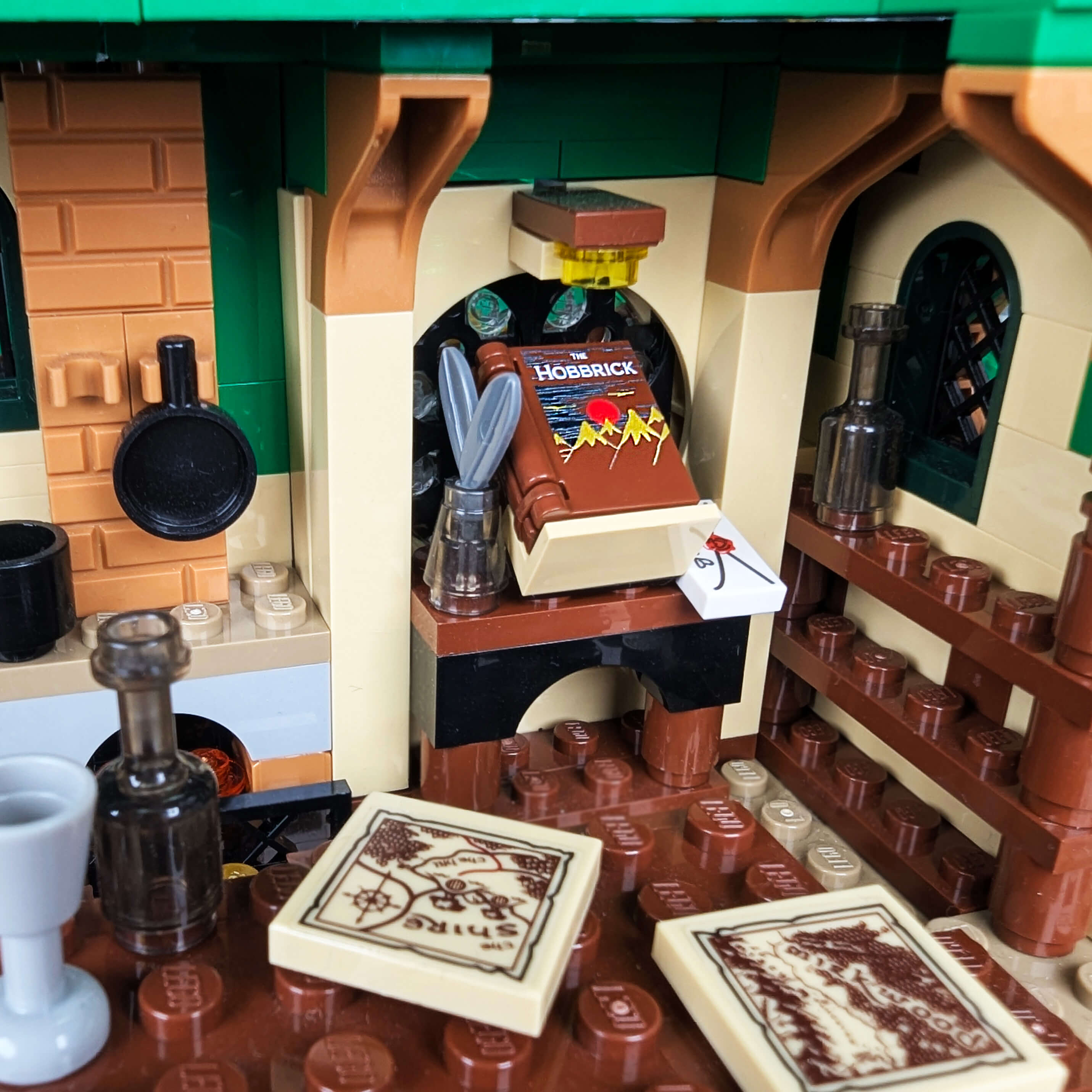 Close-up of a LEGO set with a bar area, including a bottle, glasses, and coasters.