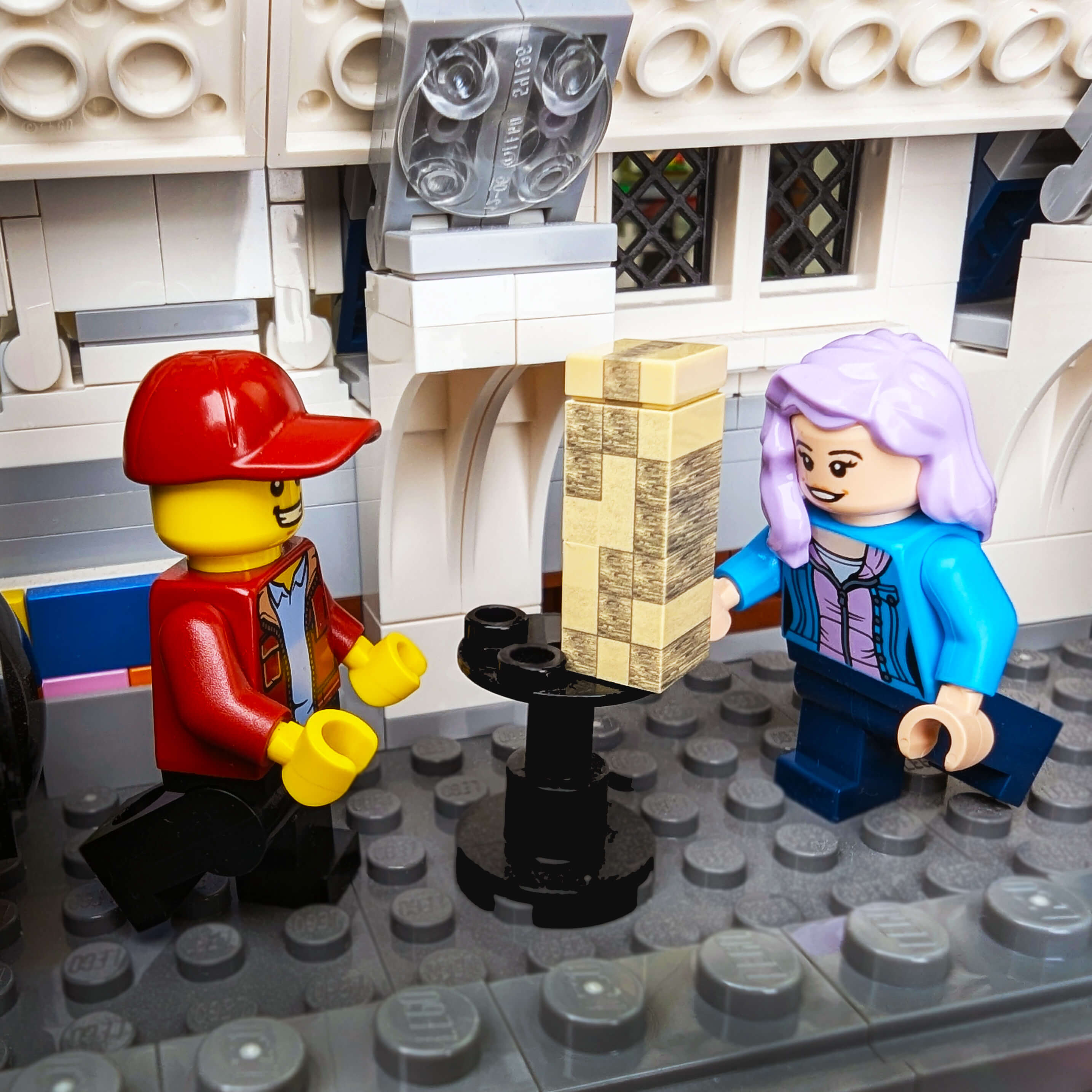 Two LEGO figures interacting with a stack of money in a detailed LEGO setting.