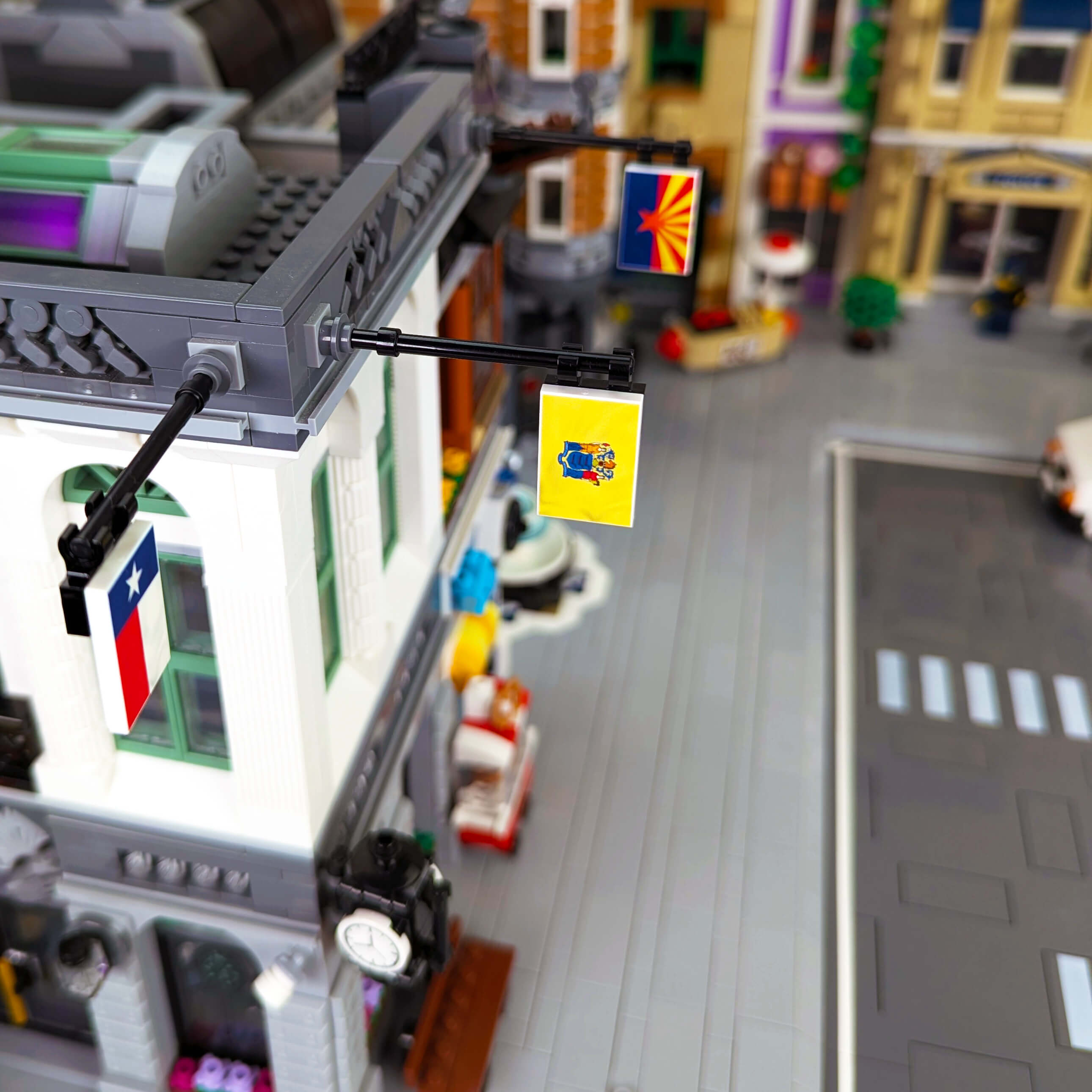 Close-up of a LEGO street scene with a New Jersey Flag, buildings and traffic lights.