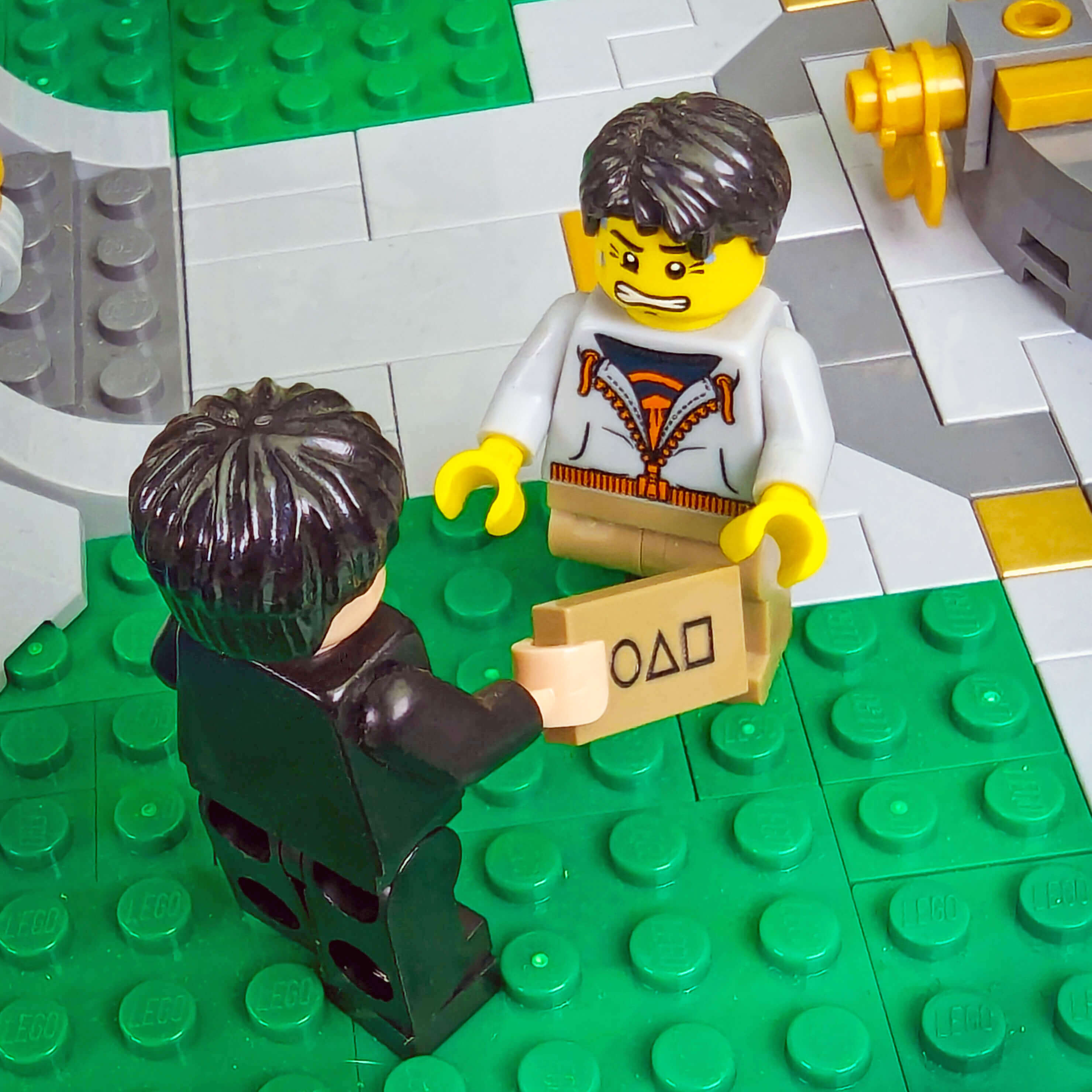 Two LEGO minifigs about to play squid games