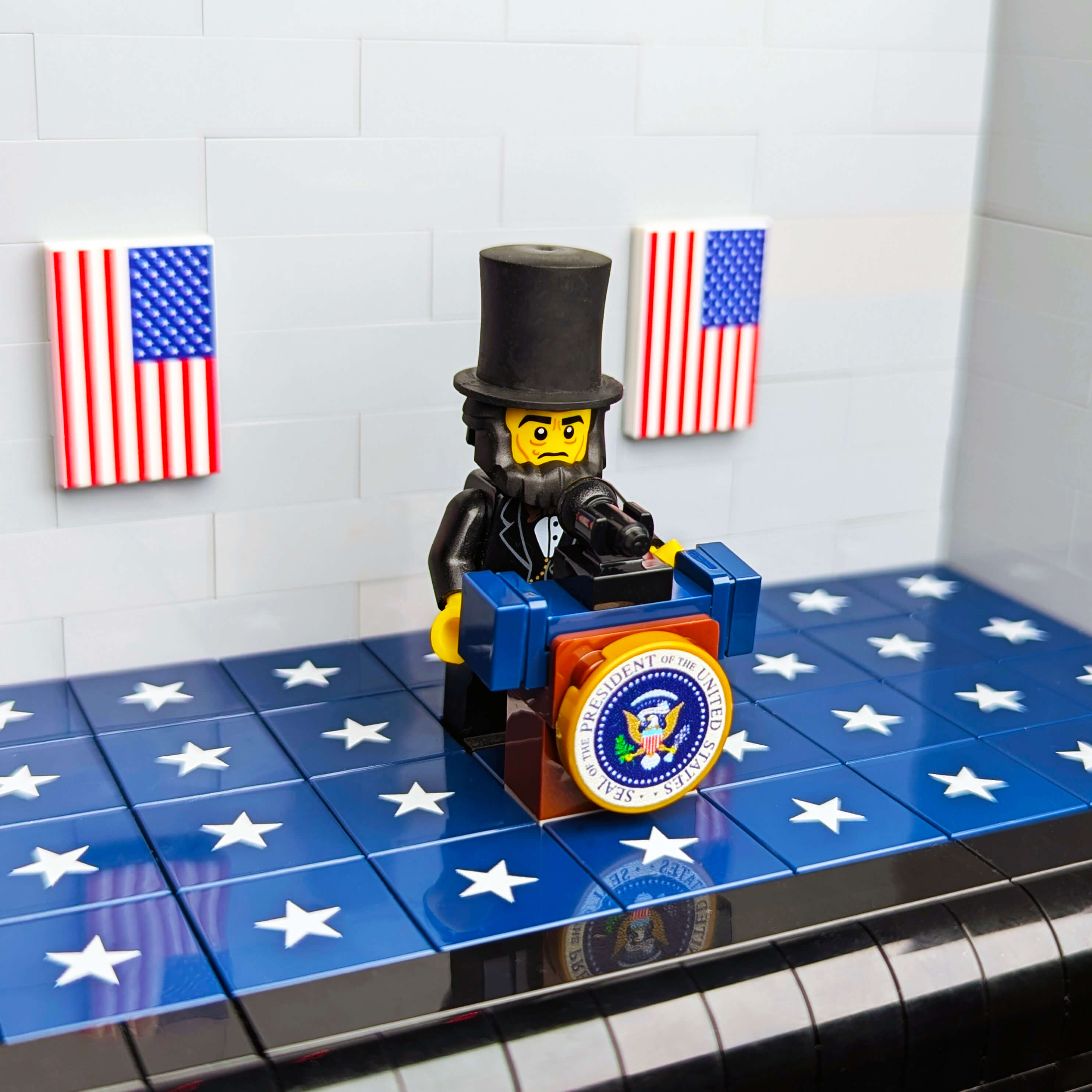 LEGO figure of a president on a blue and white star-patterned surface with American flags in the background.