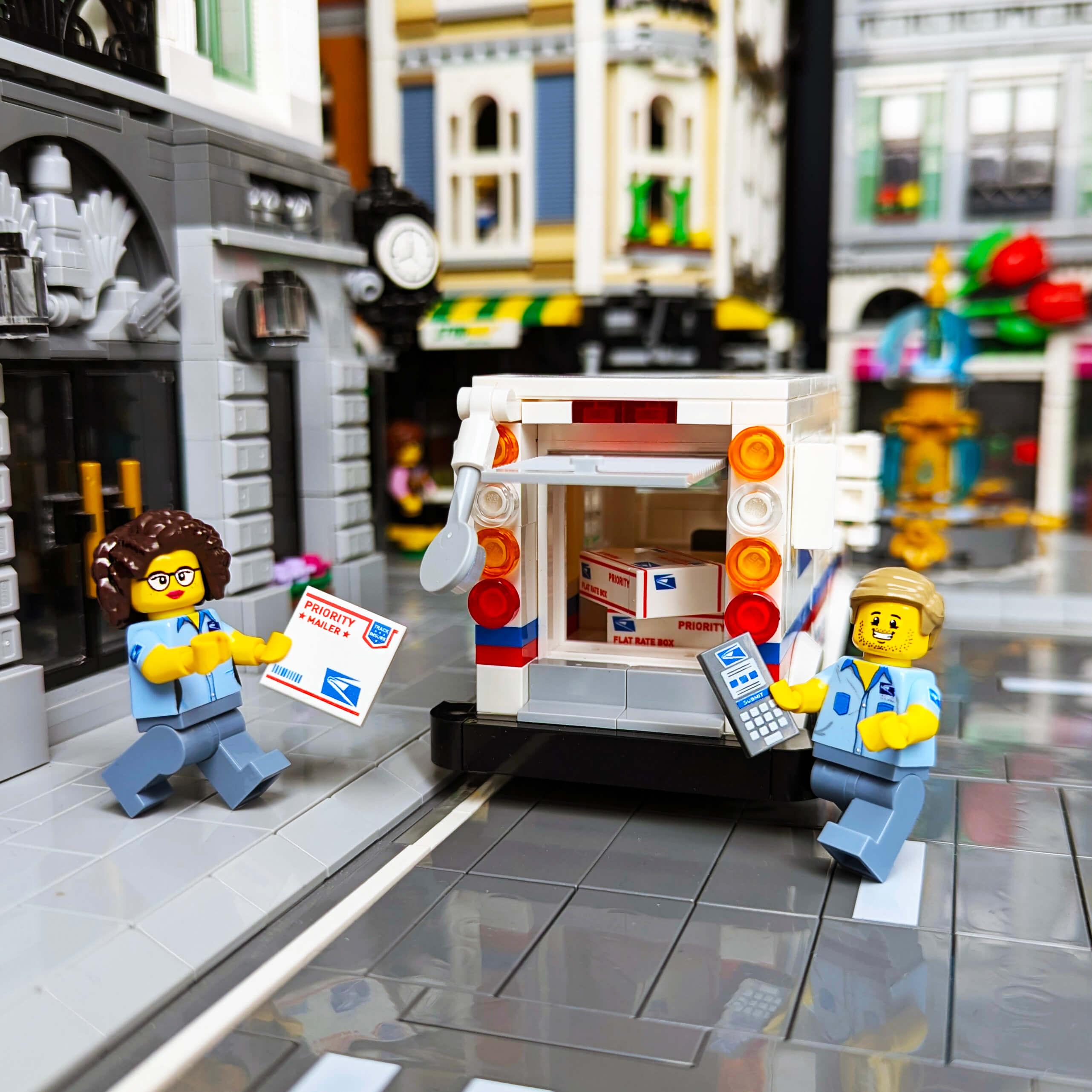 Custom printed male and female minifigures postal workers in front of a brick built mail truck.