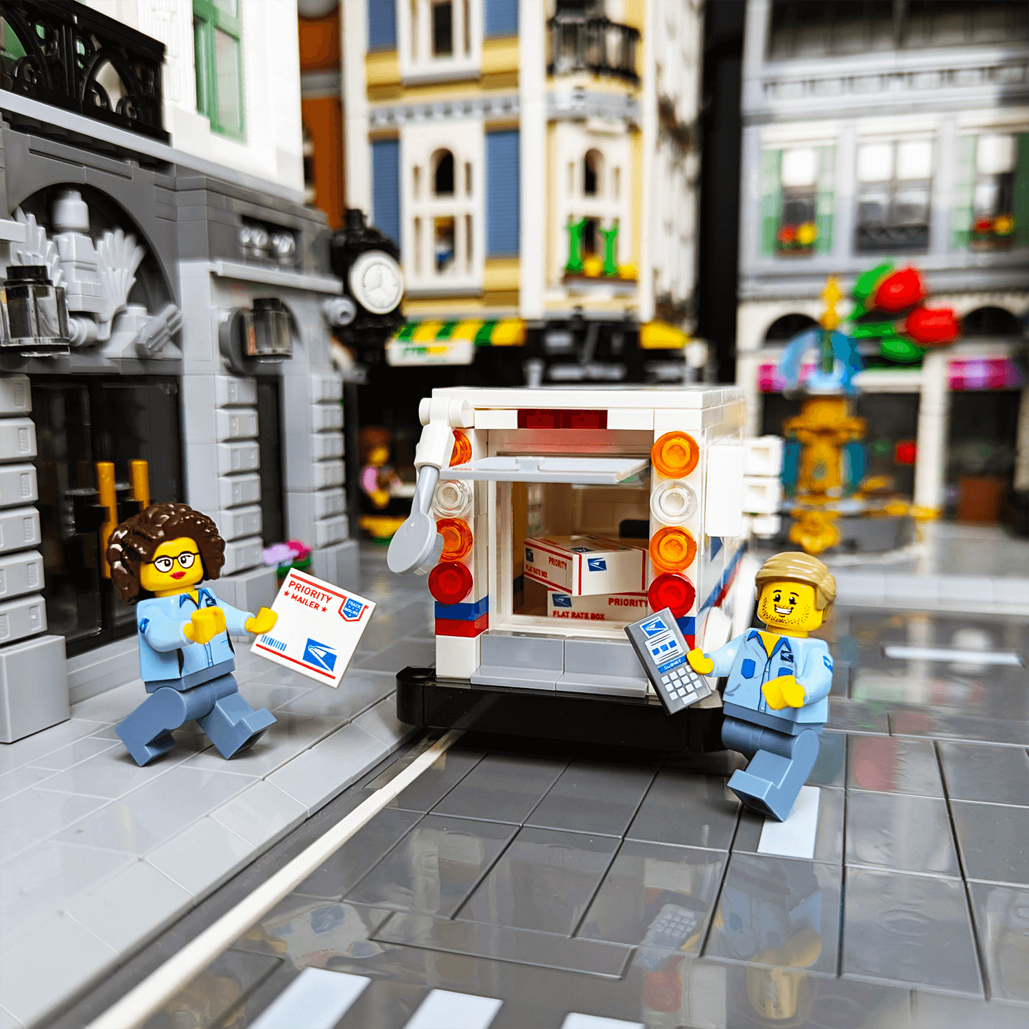 Custom printed male and female minifigs postal workers in front of a brick built mail truck on a white background.