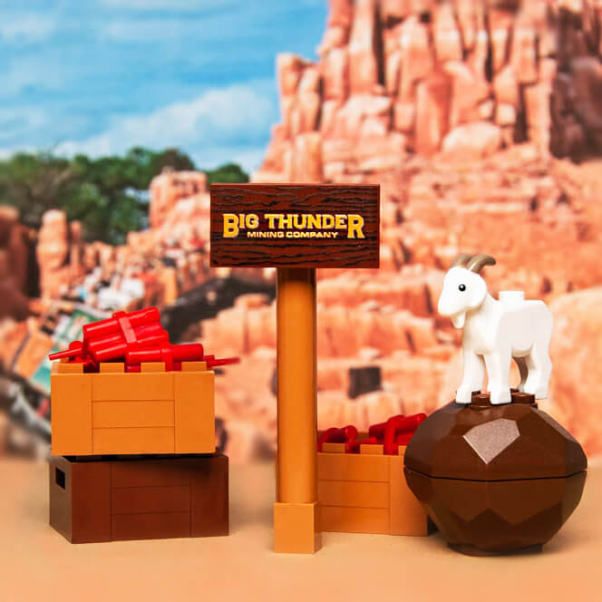 lego  etup with a sign reading 'Big Thunder Mining Company' and a goat figure in a desert-like setting.