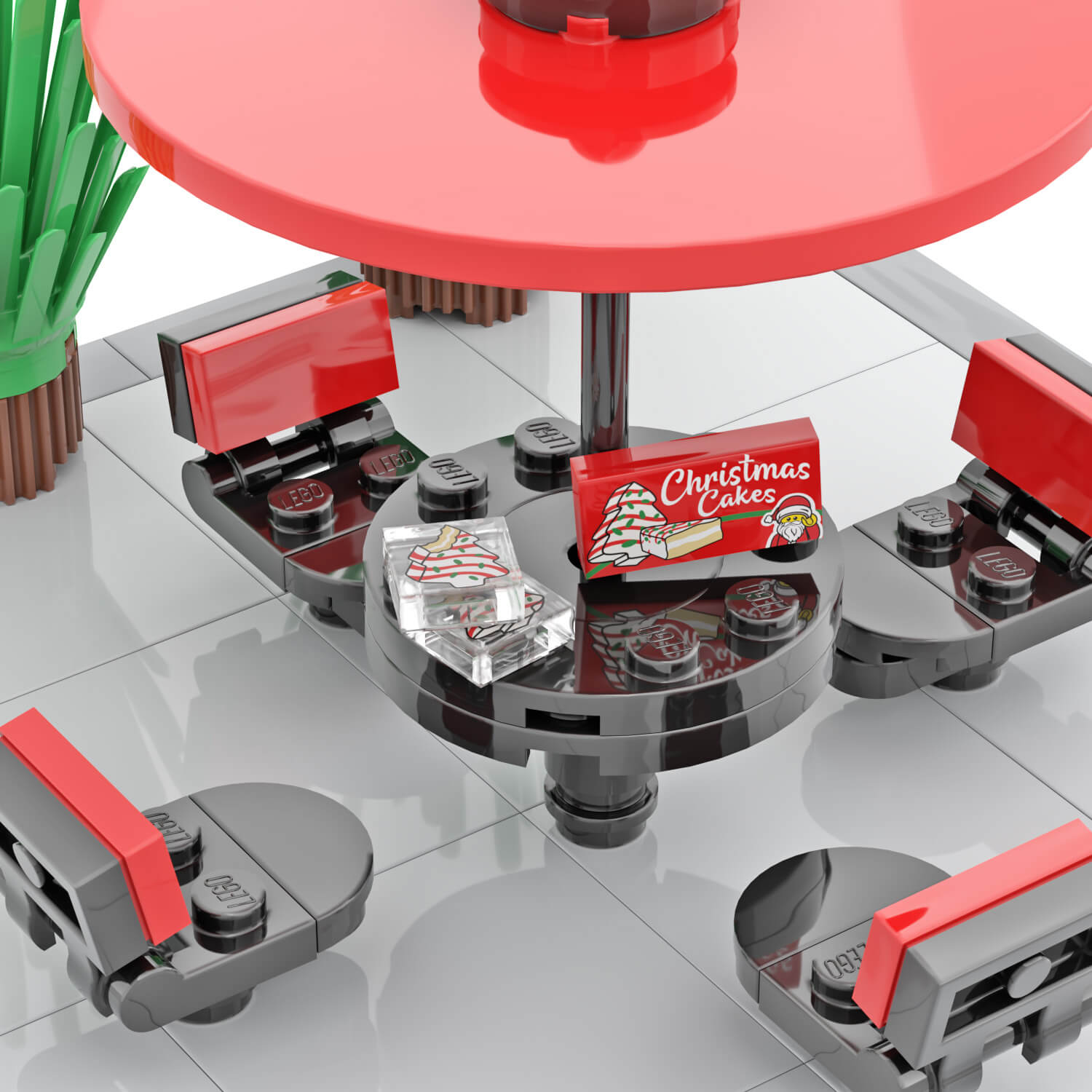 Printed LEGO Christmas cake box and cakes on a red picnic table.