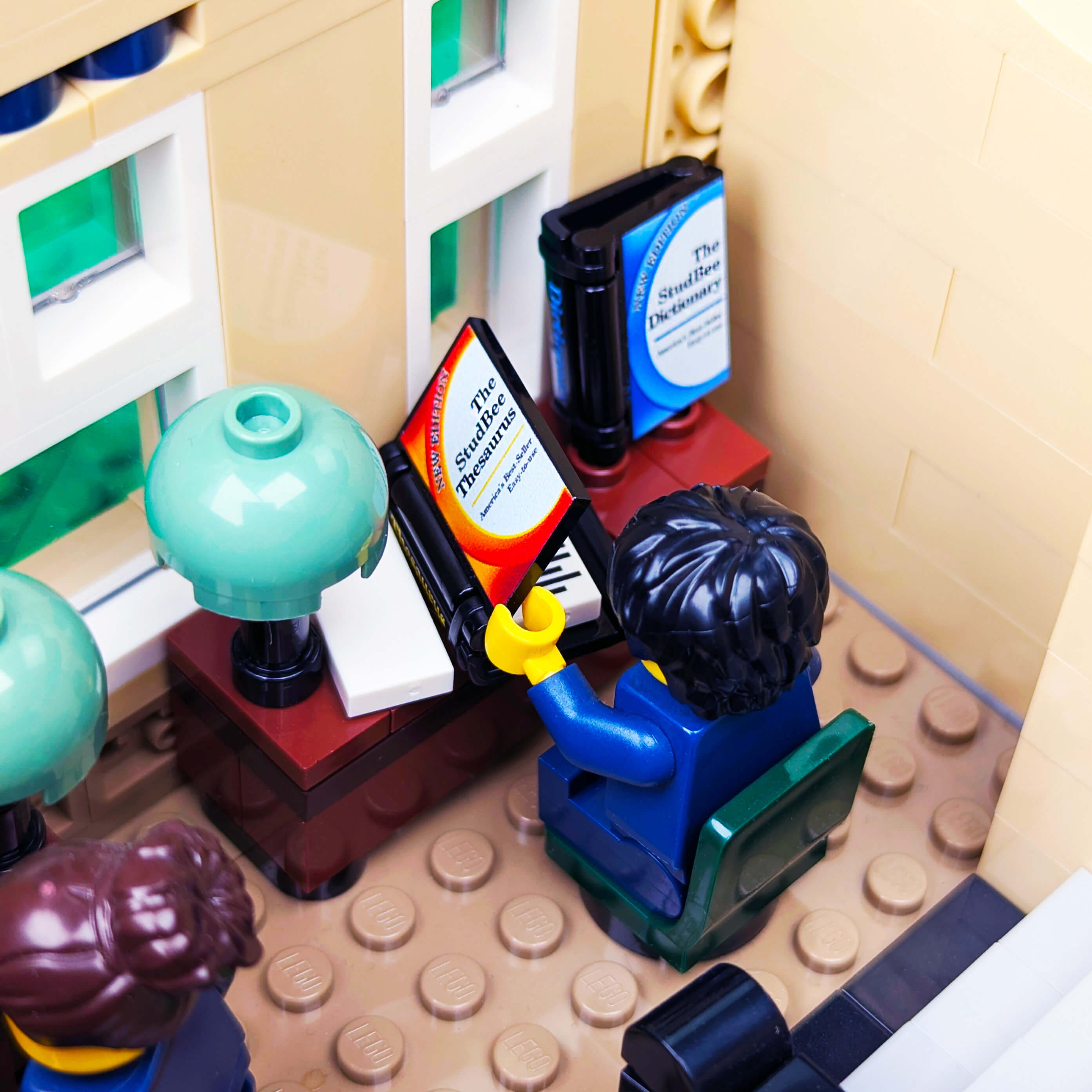 Close-up of a LEGO scene with books and a lamp