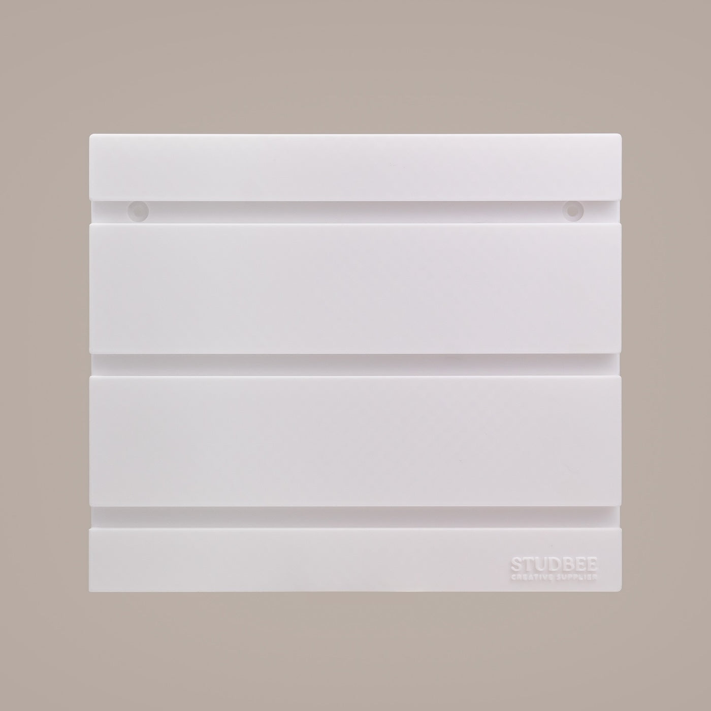 An empty four-tiered white display shelf with a geometric pattern and the brand "STUDBEE" printed on the bottom right.