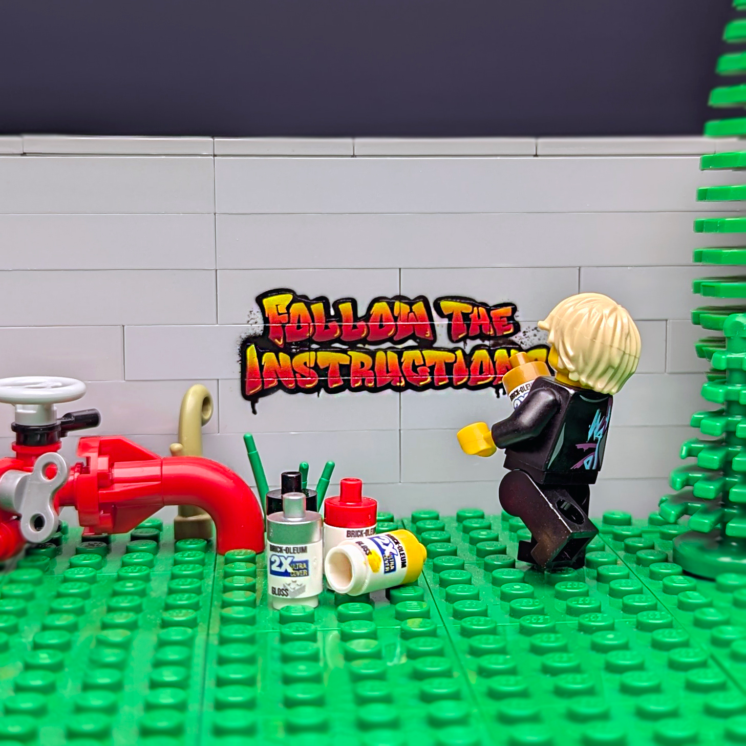 Minifigure painting "Follow the instructions" graffiti onto light bluish gray LEGO® bricks