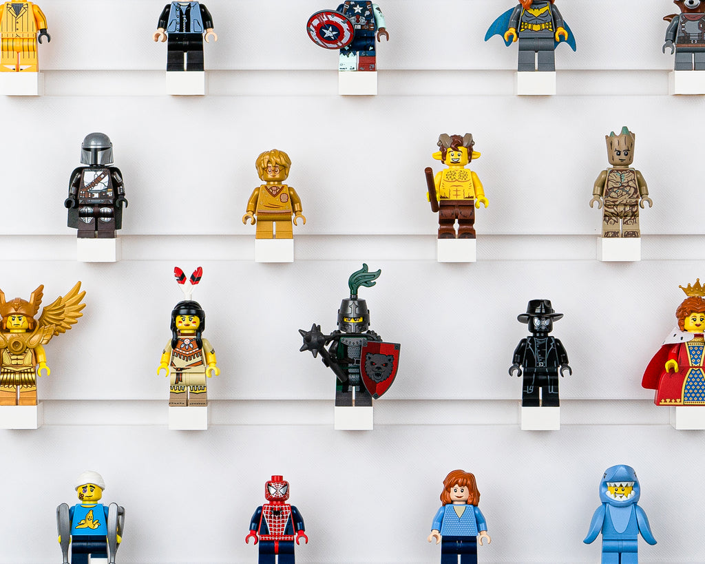 several minifigures displayed on a studbee wall board
