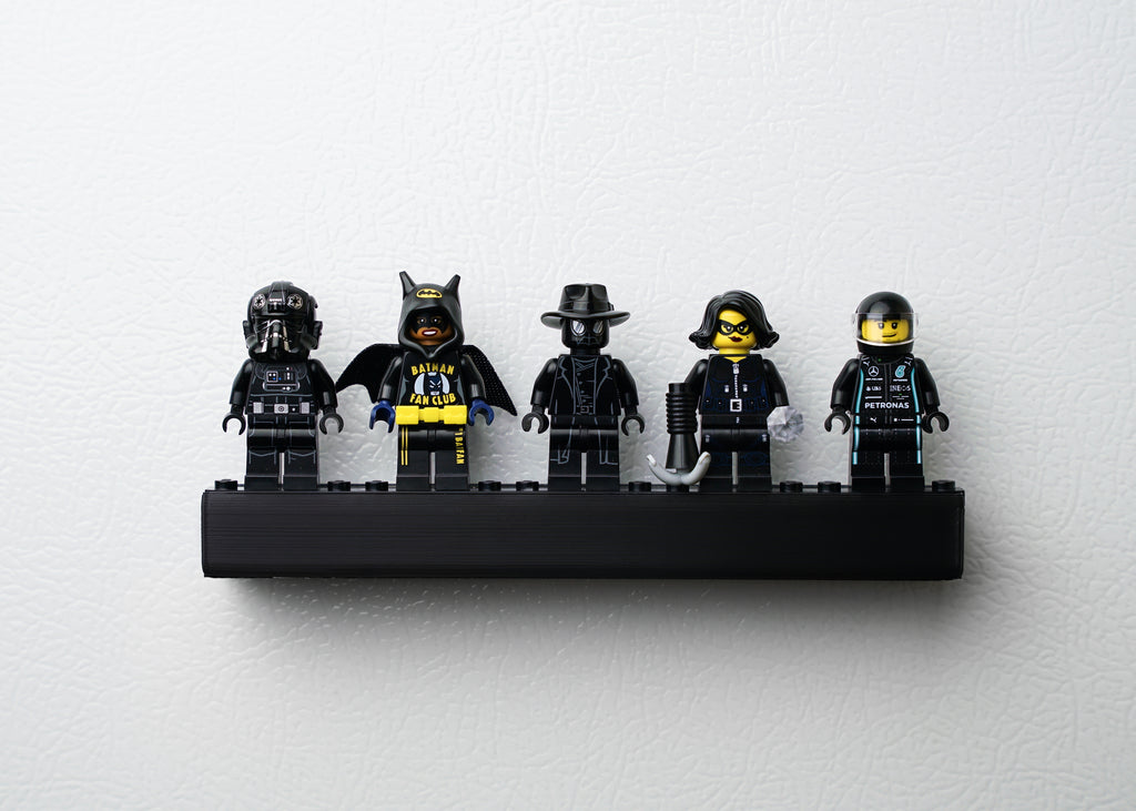five all black minifigure on a studbee black display