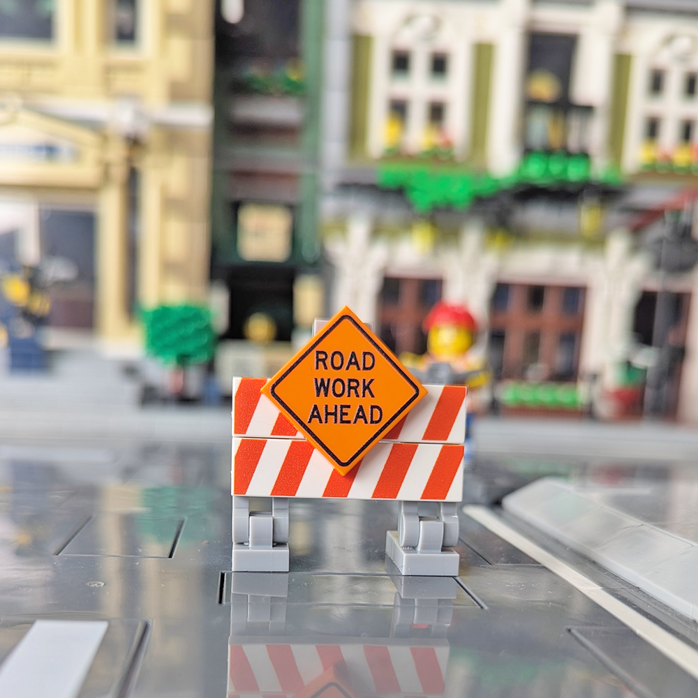 Model of a road work sign in a toy city setup.
