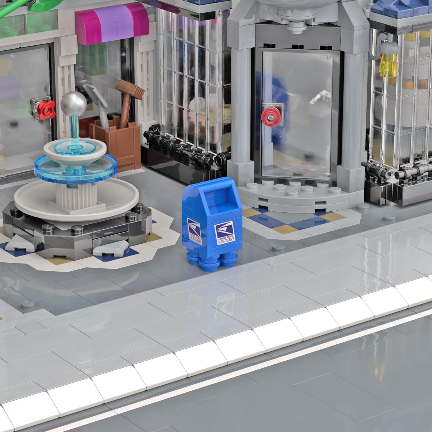 Custom designed and printed united studs blue mailbox in a LEGO city setting with fountain and side walk.