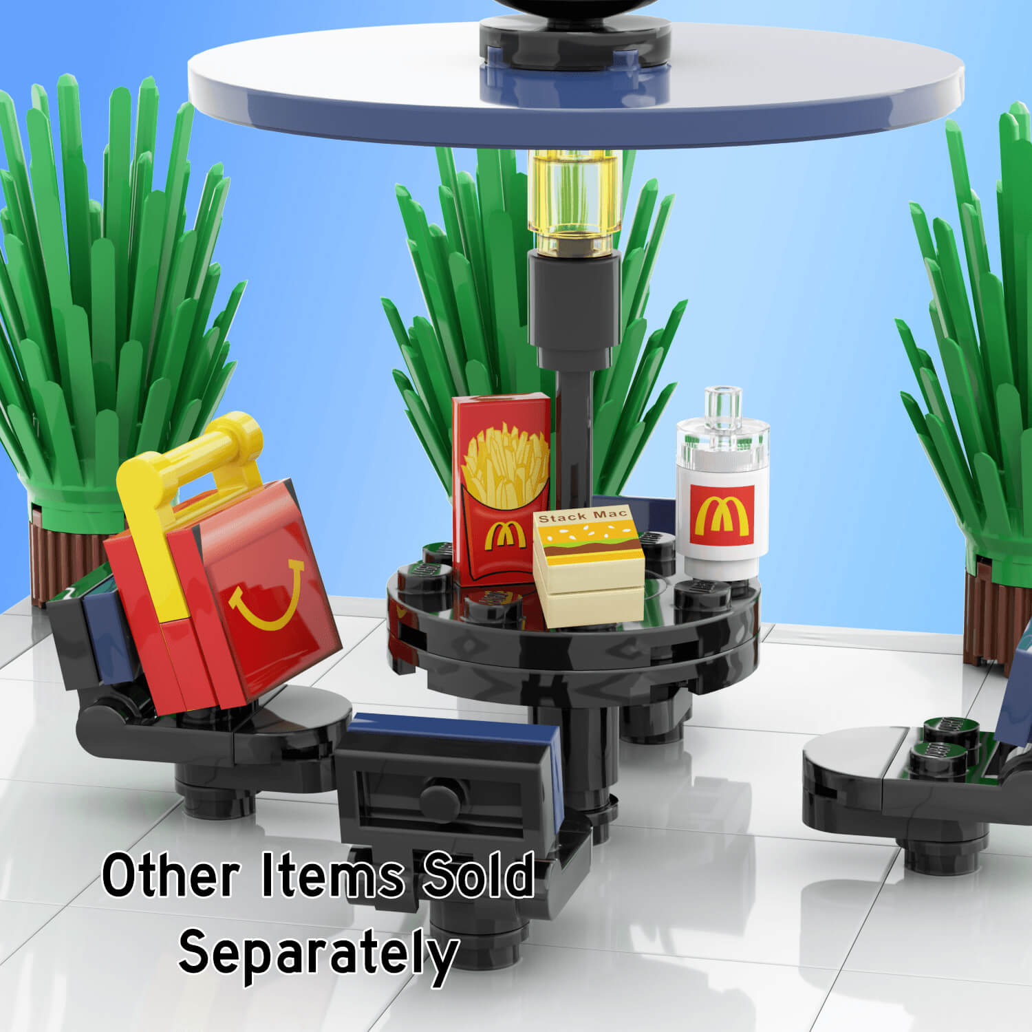 Black and blue picnic table, with mcbricks/mcdonalds kids meal, fries, stack mac,drink on the table with background plants on a light blue background.