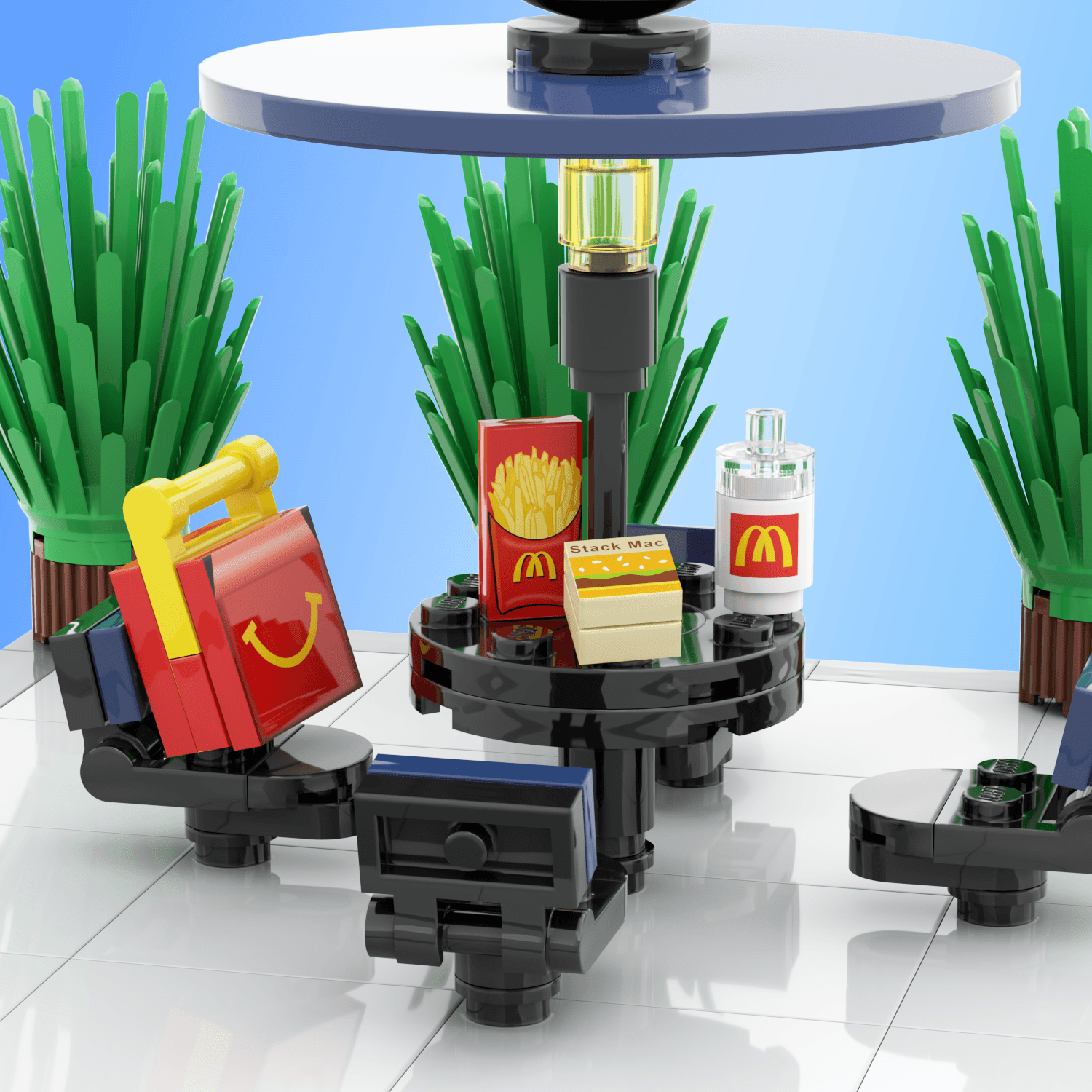 Black and blue picnic table, with mcbricks/mcdonalds kids meal, fries, stack mac,drink on the table with background plants on a light blue background.