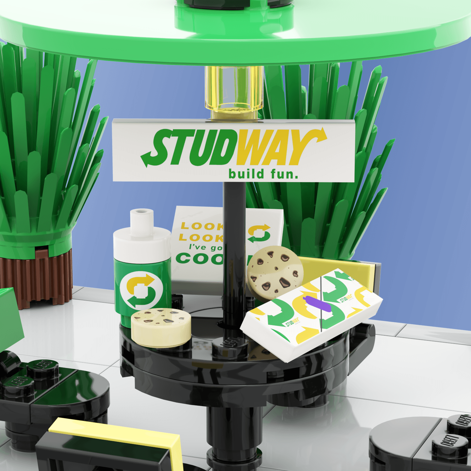 Custom designed LEGO studway food and drink, cookie pack and cookies, subway drink, and foot long sandwich on a black picnic table with a light blue background