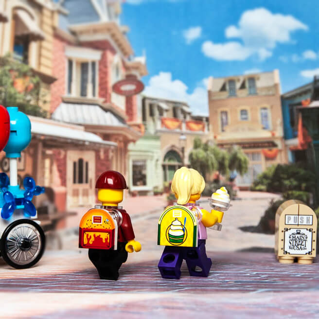 Custom printed Lego minifig backpack with a pineapple whip design, displayed in a miniature town setting.