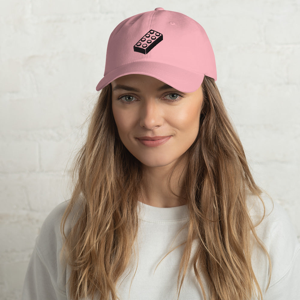 female model wearing pink lego brick dad hat